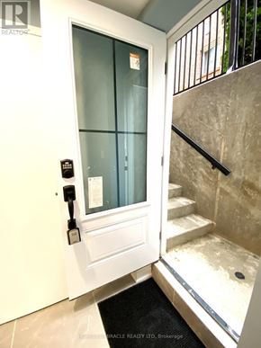Whitby (Rolling Acres) apartment for rent - A glass door with a handle and a keypad entry system.