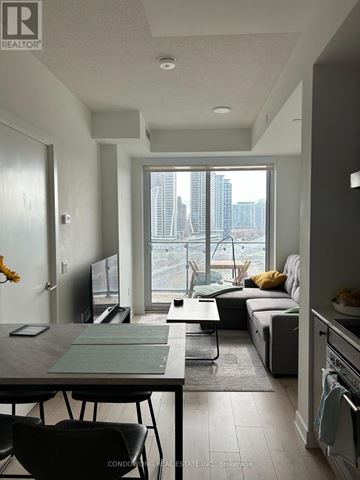 Toronto (Niagara) condo for rent - A modern kitchen with a dining table and chairs.
