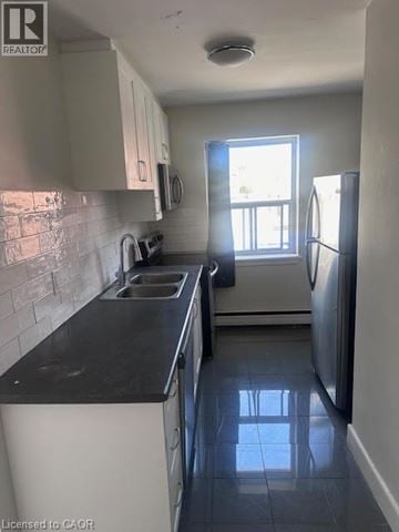 Hamilton apartment for rent - A kitchen with black countertops and white cabinets.