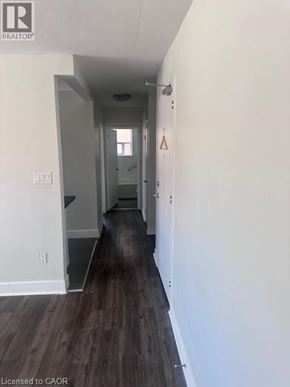 Hamilton apartment for rent - A long hallway with wood floors and white walls.