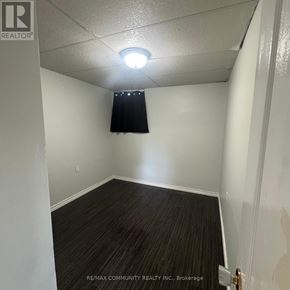 Clarington (Bowmanville) apartment for rent - A room with a dark curtain and a light switch on the wall.