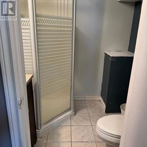 Clarington (Bowmanville) apartment for rent - A bathroom with a toilet, a sink, and a shower.