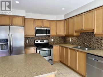 Brampton (Northwest Brampton) apartment for rent - A kitchen with wooden cabinets and a refrigerator.