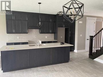 Kitchener apartment for rent - A kitchen with black cabinets and a white countertop.