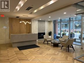 Toronto (Niagara) condo for rent - A reception area with a wooden panelled wall and a fireplace.