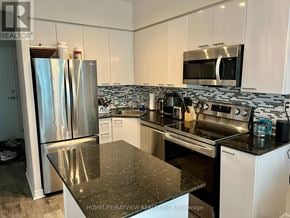 Toronto (Niagara) condo for rent - A kitchen with a granite countertop and stainless steel appliances.
