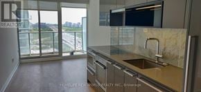 Toronto (Bayview Village) condo for rent - A kitchen with a marble countertop and a view of a highway.