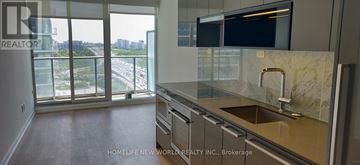 Toronto (Bayview Village) condo for rent - A kitchen with a marble countertop and a view of a highway.