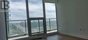 Toronto (Bayview Village) condo for rent - A room with a large window overlooking a highway.
