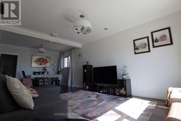 Toronto (Wexford-Maryvale) apartment for rent - A living room with a grey couch and a television.