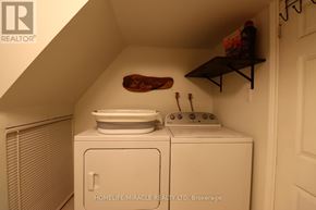 Toronto (Wexford-Maryvale) apartment for rent - A small laundry room with a washer and dryer.