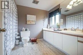 Mississauga (Meadowvale) apartment for rent - A bathroom with a toilet, sink, and shower curtain.