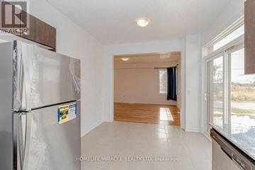 Southgate apartment for rent - A kitchen with a refrigerator and a window.