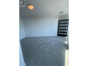 Vancouver apartment for rent - A room with a grey floor and a black ladder.