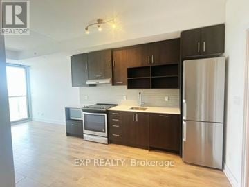 Toronto (Don Valley Village) condo for rent - A kitchen with dark brown cabinets and stainless steel appliances.