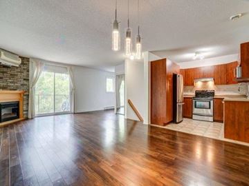 Gatineau (Hull) condo for rent - A spacious kitchen with wooden cabinets and a stainless steel refrigerator.