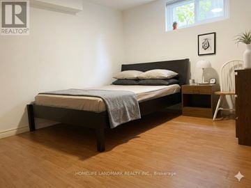 Toronto (Steeles) apartment for rent - A bedroom with a bed, nightstand, and lamp.