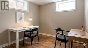 Toronto (Steeles) apartment for rent - A room with a desk, chair and a table with a chair.