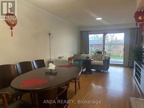 Toronto (West Hill) apartment for rent - A dining room with a table and chairs and a sofa in the background.
