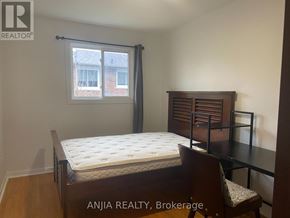Toronto (West Hill) apartment for rent - A bedroom with a bed, chair, and window.