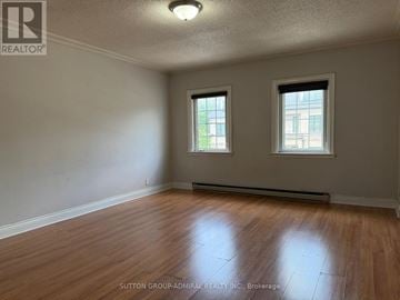 Toronto (Lawrence Park South) multi-family for rent - A room with wooden floors and two windows.