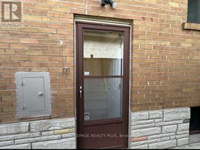 Toronto (Markland Wood) apartment for rent - A brown door with a glass window is on a brick wall.