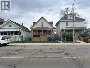 Windsor apartment for rent - A street with houses and a car parked on the side.