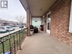 Windsor apartment for rent - A balcony with a brick wall and a metal railing.