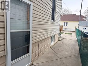 Windsor apartment for rent - A house with a grey siding and a white door is shown.