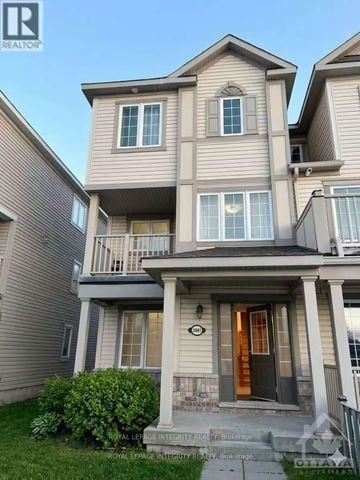 Ottawa townhouse for rent - A two-story house with a balcony on the second floor.