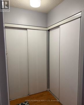 Toronto (Mount Olive-Silverstone-Jamestown) house for rent - A room with white walls and a wooden floor with a brokerage sign.
