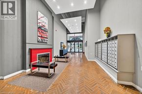 Hamilton condo for rent - A hallway with a red fireplace and a painting on the wall.