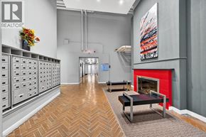 Hamilton condo for rent - A room with a red fireplace and a painting on the wall.