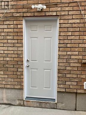 Kitchener apartment for rent - A grey door is set in a brick wall.