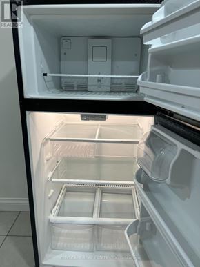 Hamilton (Winona Park) apartment for rent - A white refrigerator with the door open showing the empty shelves.
