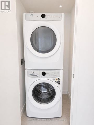 Toronto (North St. James Town) condo for rent - A white washing machine and dryer in a small laundry room.