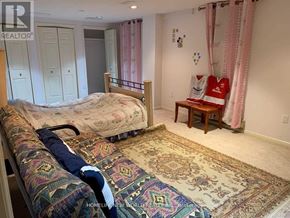 Toronto (Bayview Village) apartment for rent - A bedroom with a bed, a bench, and a rug.