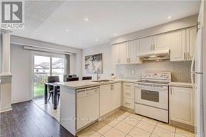 Markham (Greensborough) townhouse for rent - A well-lit kitchen with white appliances and cabinets.