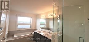 Newmarket (Woodland Hill) townhouse for rent - A bathroom with a tub, sink, mirror, and shower.
