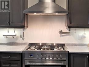 Newmarket (Woodland Hill) townhouse for rent - A modern kitchen with a stove top oven and a range hood.