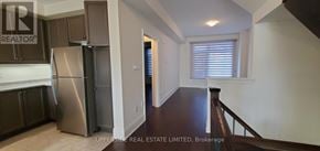 Newmarket (Woodland Hill) townhouse for rent - A kitchen with a refrigerator and cabinets.