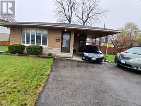 Niagara Falls (Morrison) apartment for rent - A house with a car parked in front of it.