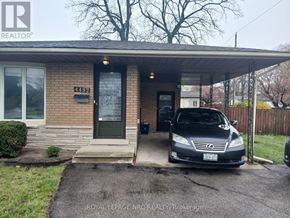 Niagara Falls (Morrison) apartment for rent - A black car is parked in front of a house with the number 44192 on the front door.
