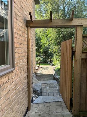 Toronto (Edenbridge-Humber Valley) apartment for rent - A wooden gate is open to a stone pathway.