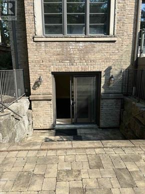 Toronto (Edenbridge-Humber Valley) apartment for rent - A stone building with a doorway and windows.