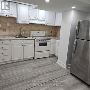 Richmond Hill (Devonsleigh) apartment for rent - A kitchen with white cabinets and a stainless steel refrigerator.