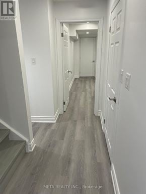 Whitchurch-Stouffville (Stouffville) apartment for rent - A hallway with wood flooring and white walls.