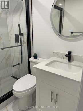 Whitchurch-Stouffville (Stouffville) apartment for rent - A white toilet sits next to a sink in a bathroom.
