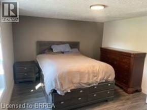 Brantford apartment for rent - A bedroom with a bed, nightstand, and dresser.