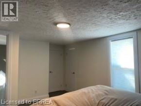 Brantford apartment for rent - A room with a bed and a window.